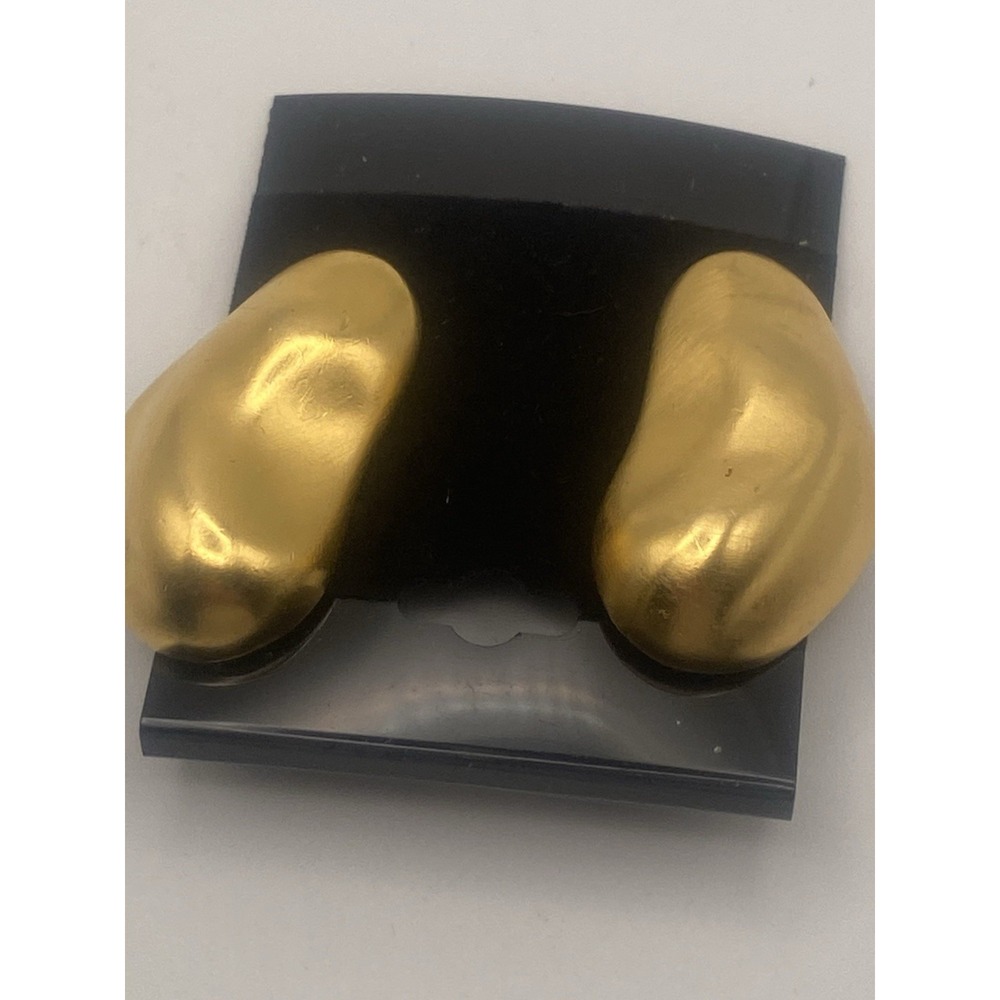 matte gold-tone, bean-shaped clip-on earrings with a smooth, curved design